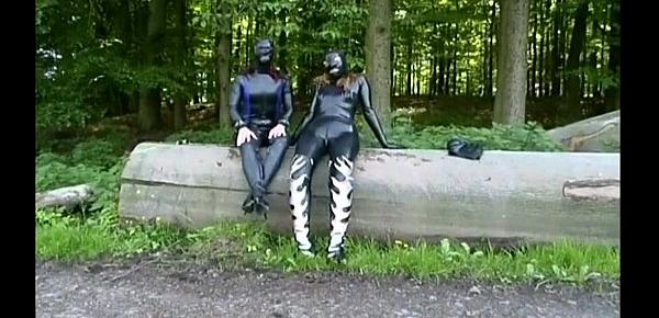  Two girls in latex touch each other